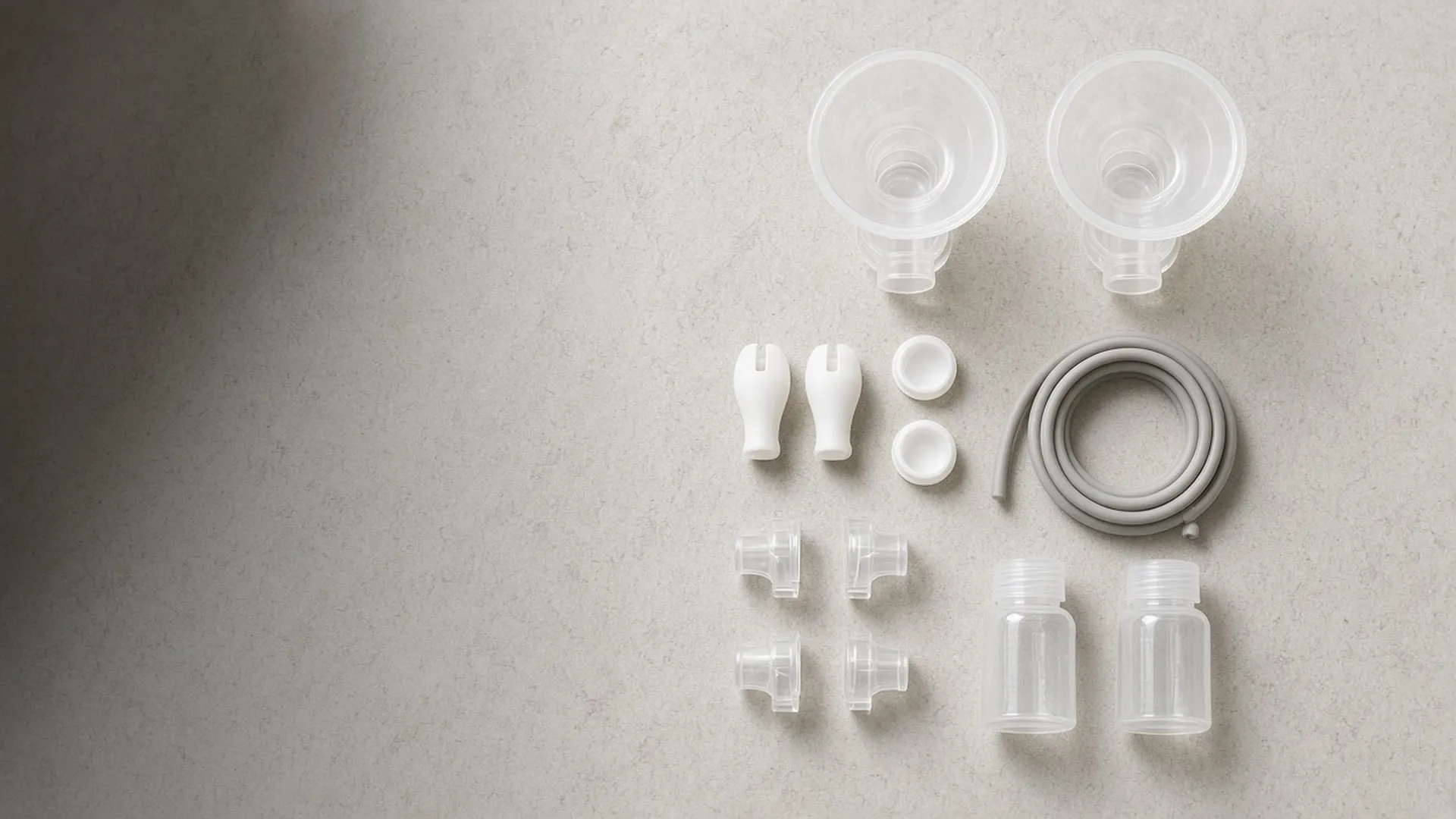 Clean pump parts laid out in a grid on stone